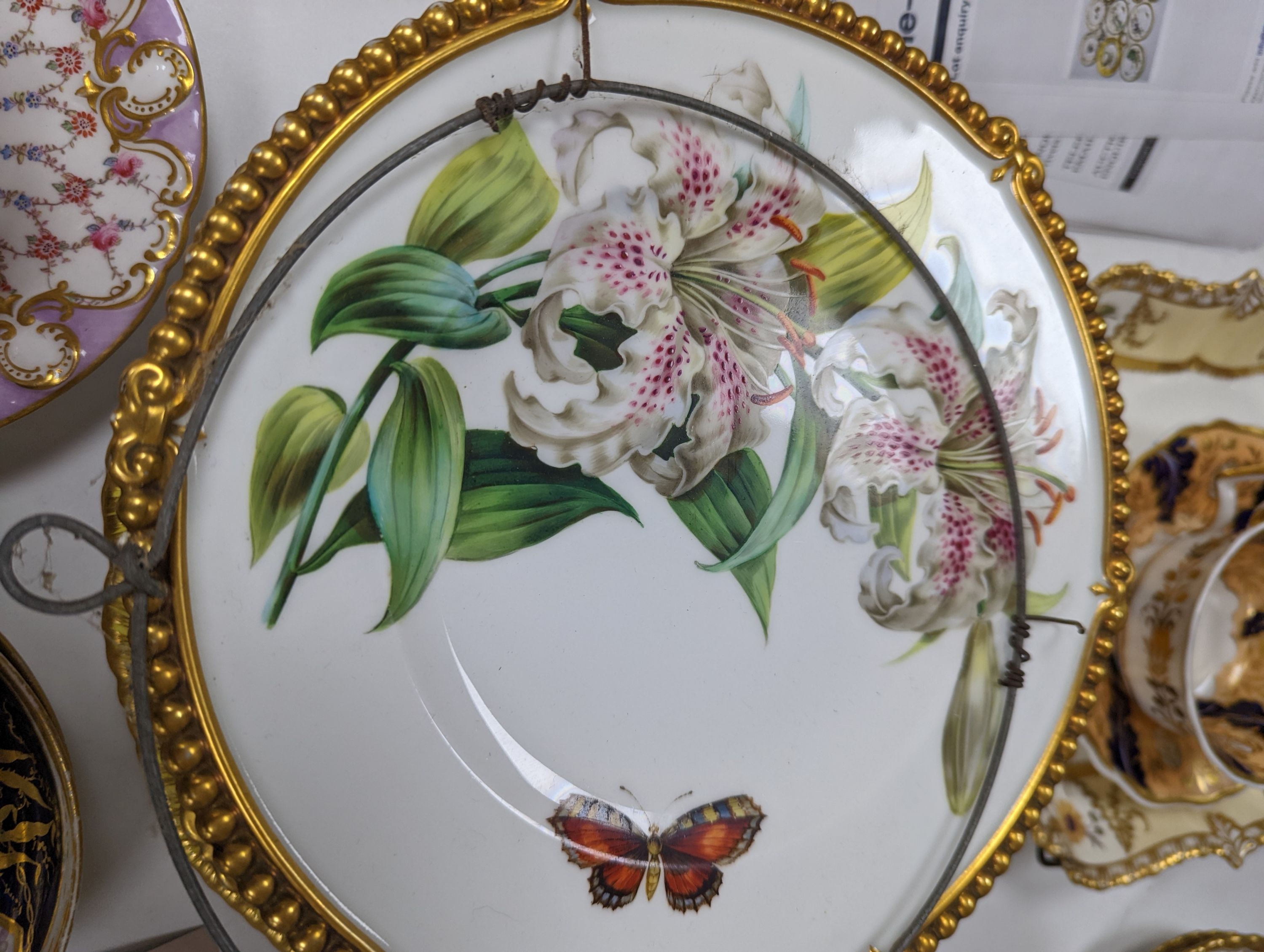 A small collection of Victorian porcelain tea cups and saucers and sundry dessert plates